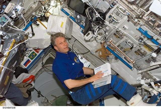 NASA image: Reiter reads procedures while working in the U.S. Lab during STS-121 / Expedition 13 joint operations