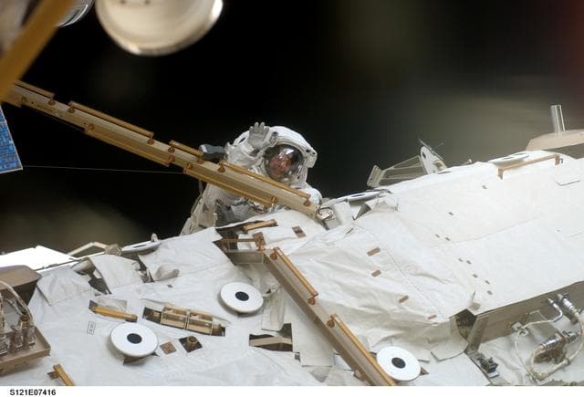 NASA image: Fossum waves to the camera from the S1 Truss during EVA3 on STS-121 / Expedition 13 joint operations