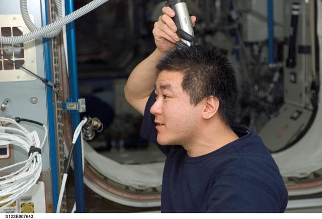 NASA image: Tani trims his hair in Node 2