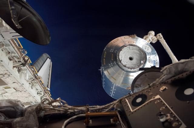 NASA image: Columbus being moved into installation position by the SSRMS