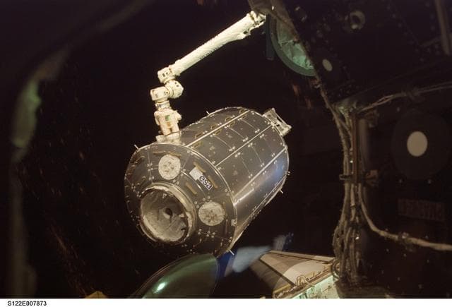 NASA image: Columbus being moved into installation position by the SSRMS