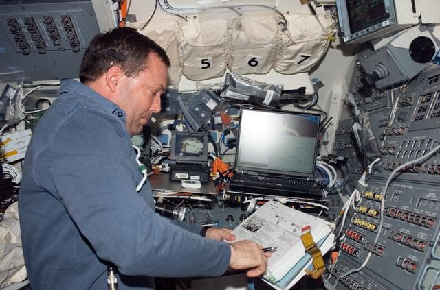 NASA image: Foreman looks over crew procedures during Expedition 16 / STS-123 Joint Operations
