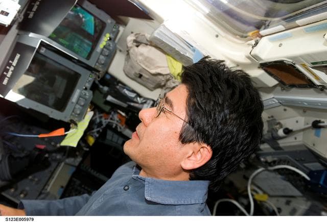 NASA image: Doi watches monitor during first EVA, Joint Operations