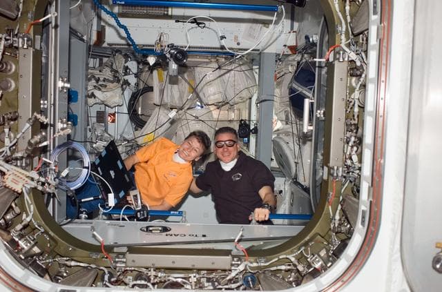 NASA image: Whitson and Johnson in the Node 2 hatch during STS-123 / Expedition 16 Joint Operations