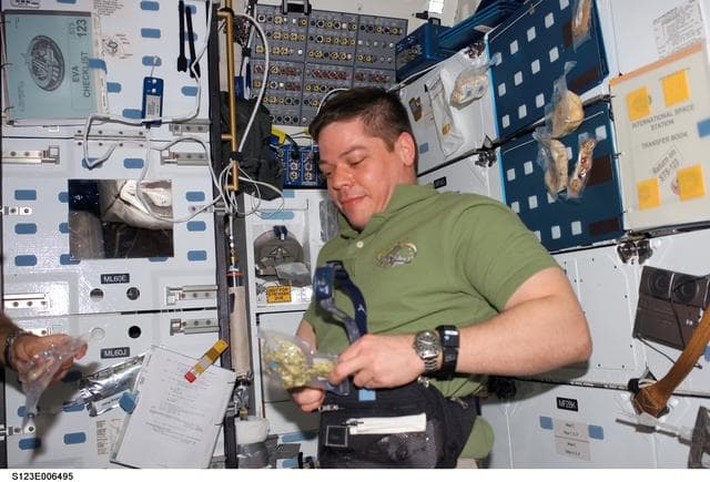 NASA image: Behnken open food package in the MDDK on Space Shuttle Endeavour