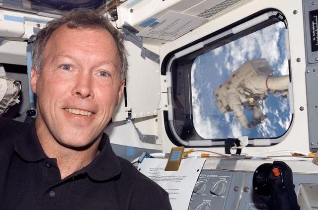 NASA image: Linnehan anchored to a Canadarrm2 mobile foot restraint during Expedition 16 / STS-123 Joint Operations
