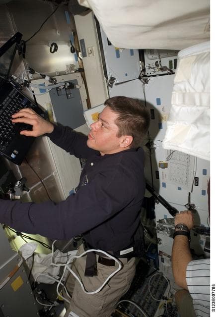 NASA image: Behnken works on computer in the FWD MDDK during Joint Operations