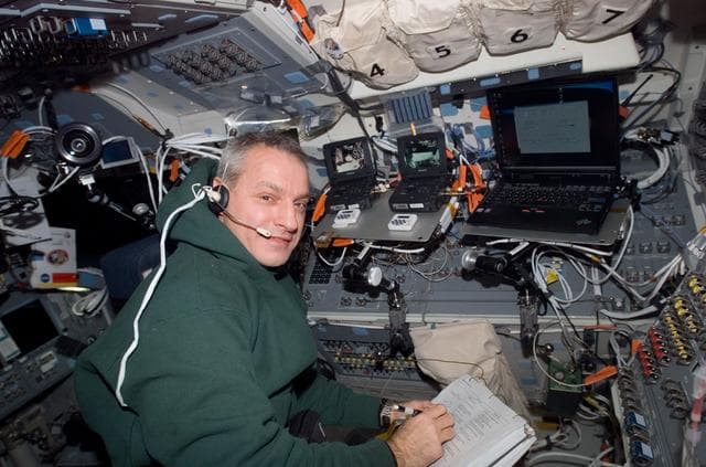 NASA image: Linnehan looks over crew procedures in the aft FD during Joint Operations