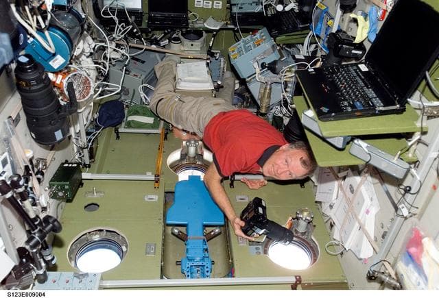 NASA image: Gorie takes pictures at the SM window during Joint Operations