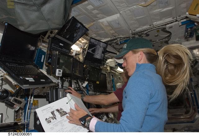 NASA image: Nyberg and Hoshide at SSRMS controls