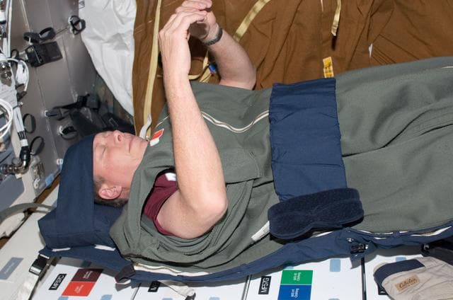 NASA image: Fossum in sleeping bag on middeck