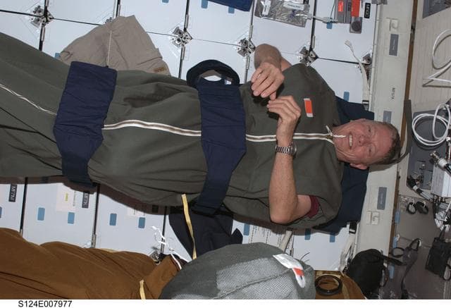 NASA image: Fossum in sleeping bag on middeck