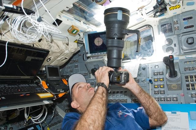NASA image: STS-125 Crew working on the Shuttle Atlantis Flight Deck during HST Rendezvous