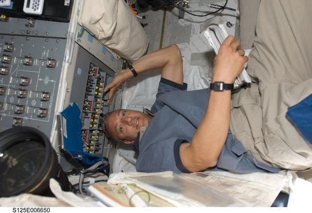 NASA image: STS-125 Crew working on the Shuttle Atlantis Flight Deck during HST Rendezvous