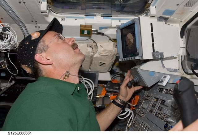 NASA image:  STS-125 Crew working on the Shuttle Atlantis Flight Deck during HST Rendezvous