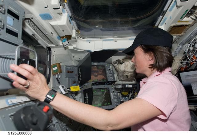 NASA image: STS-125 Crew working on the Shuttle Atlantis Flight Deck during HST Rendezvous