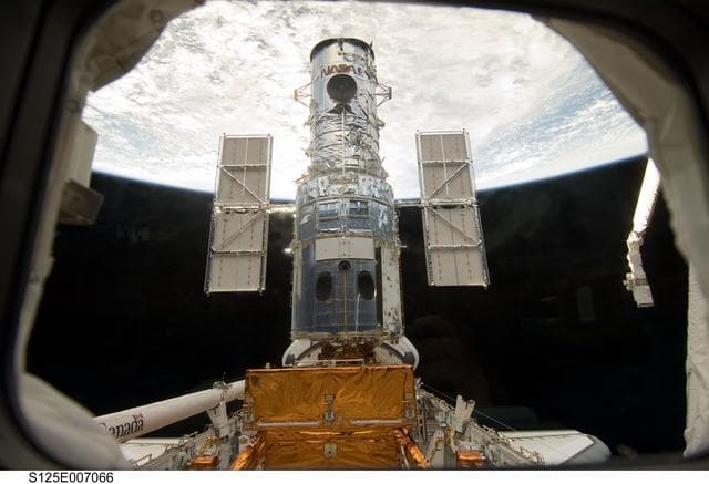 NASA image: View of the HST docked with the Space Shuttle Atlantis