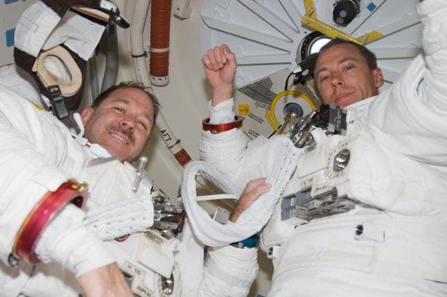 NASA image: STS-125 Feustel and Grunsfeld in the Airlock after EVA1
