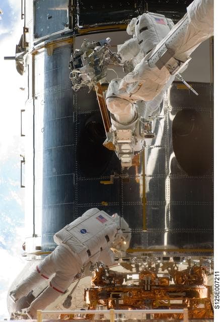 NASA image: STS-125 MS5 Feustel and MS3 Grunsfeld during EVA1