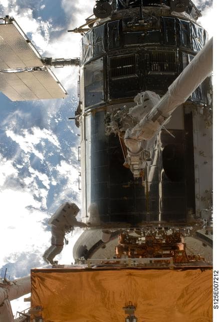 NASA image: STS-125 MS5 Feustel and MS3 Grunsfeld during EVA1