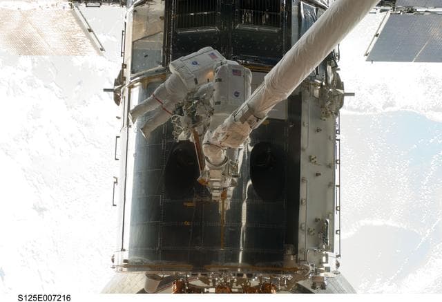 NASA image: STS-125 MS5 Feustel and MS3 Grunsfeld during EVA1