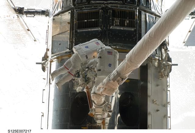 NASA image: STS-125 MS5 Feustel and MS3 Grunsfeld during EVA1