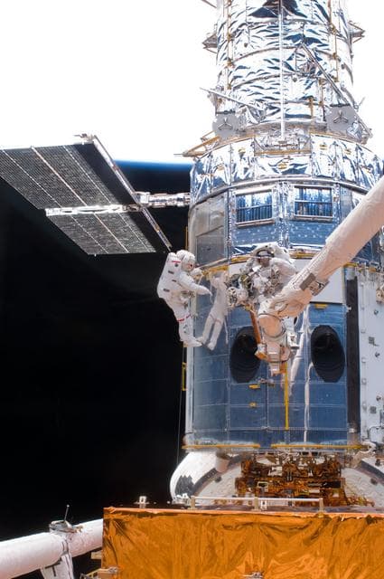 NASA image: STS-125 MS5 Feustel and MS3 Grunsfeld during EVA1