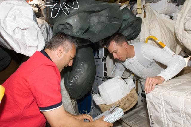 NASA image: STS-125 Crew Members prepare for EVA1 in the Middeck