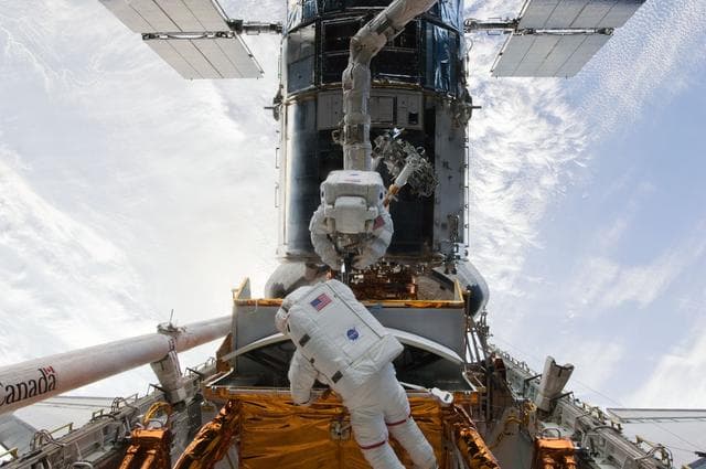 NASA image: STS-125 MS5 Feustel and MS3 Grunsfeld during EVA1