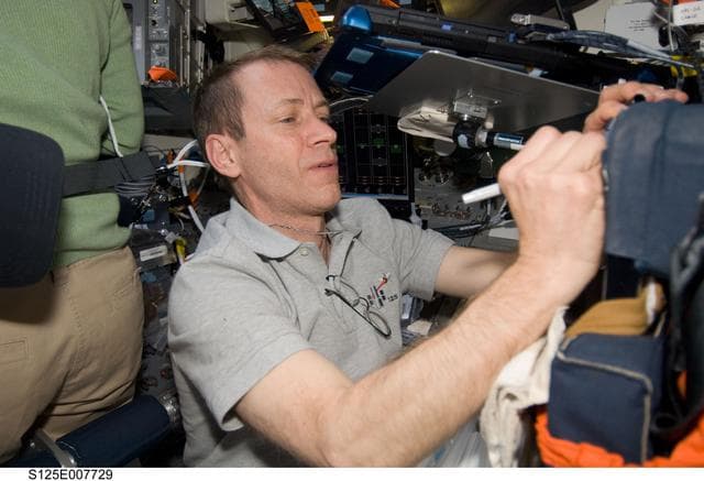 NASA image: STS-125 Pilot Johnson works on the FD during Flight Day 5