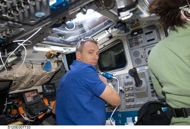 NASA image: STS-125 MS 5 Feustel poses for a photo on the FD during Flight Day 5