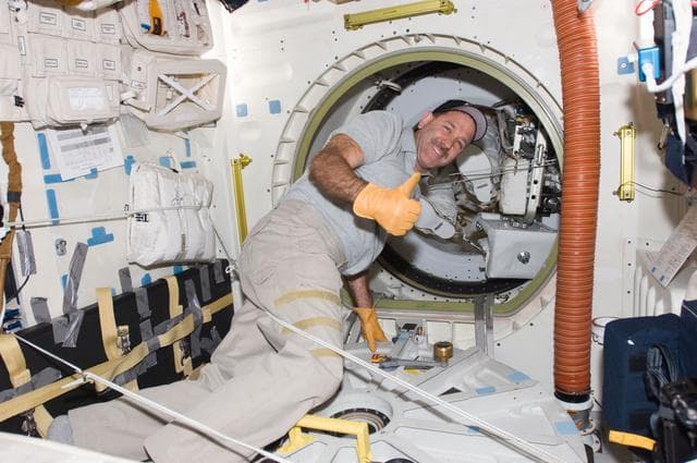 NASA image: STS-125 MS3 Grunsfeld opens the Atlanis Airlock Hatch after EVA2