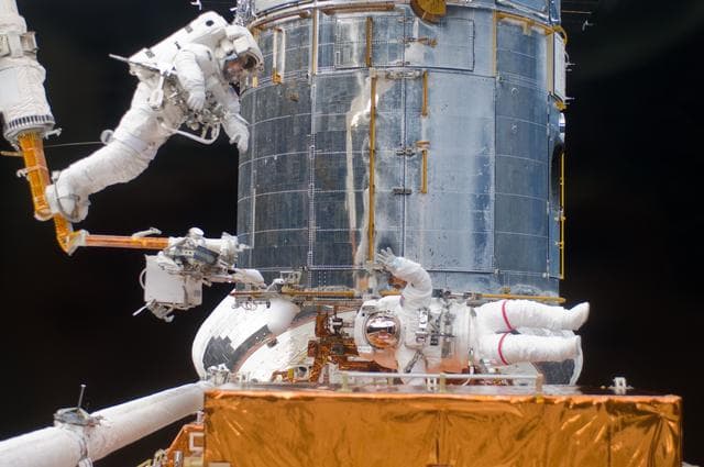 NASA image: STS-125 MS5 Feustel and MS3 Grunsfeld during EVA3