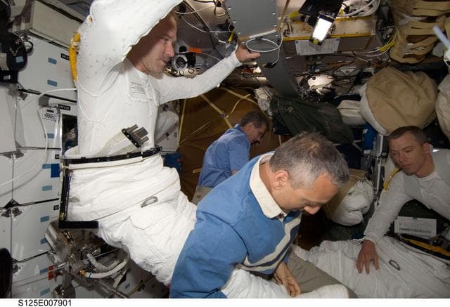 NASA image: STS-125 Crew Members prepare for EVA3 in the MDDK