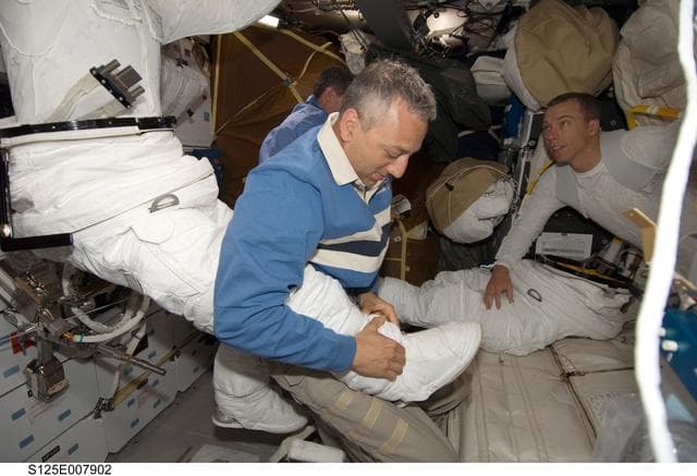 NASA image: STS-125 Crew Members prepare for EVA3 in the MDDK