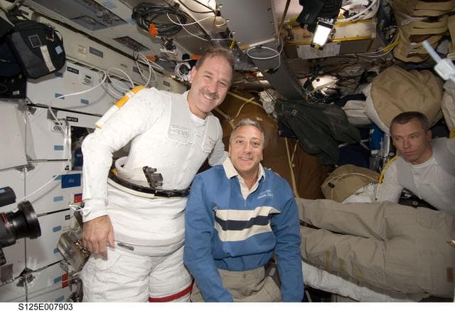 NASA image: STS-125 Crew Members pose for a photo in the MDDK