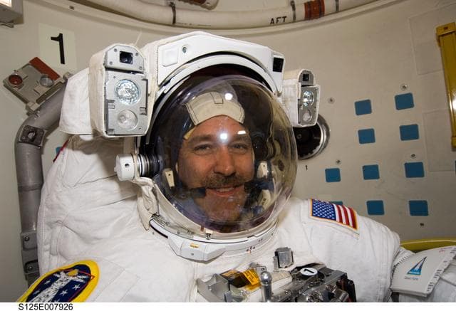 NASA image: STS-125 MS3 Grunsfeld poses for a photo in the Airlock prior to EVA3