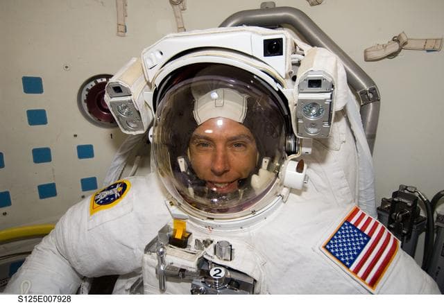 NASA image: STS-125 MS5 Feustel poses for a photo in the Airlock prior to EVA3