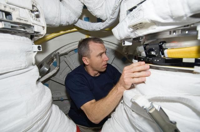 NASA image: STS-125 MS5 Feustel works with an EMU