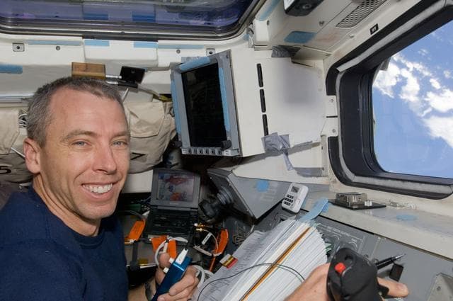 NASA image: STS-125 MS5 Andrew Feustel works on the Flight Deck during Flight Day 7