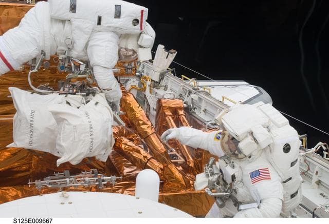 NASA image: STS-125 MS3 Grunsfeld and MS5 Feustel during EVA5