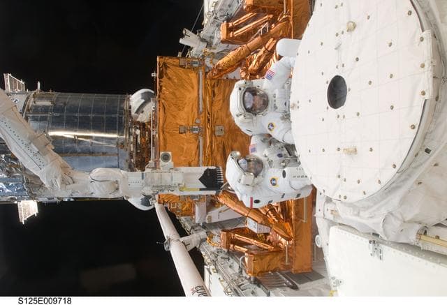NASA image: STS-125 MS3 Grunsfeld and MS5 Feustel during EVA5