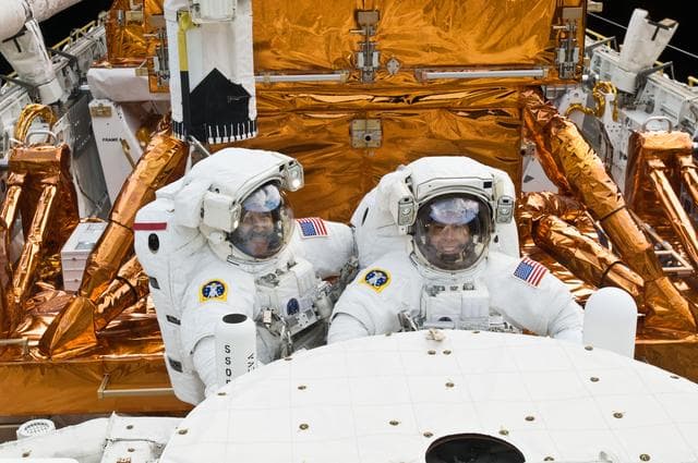 NASA image: STS-125 MS3 Grunsfeld and MS5 Feustel during EVA5