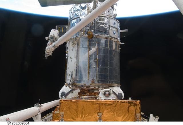 NASA image: STS-125 MS3 Grunsfeld and MS5 Feustel during EVA5