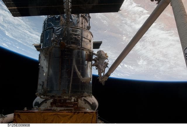 NASA image: STS-125 MS3 Grunsfeld and MS5 Feustel during EVA5