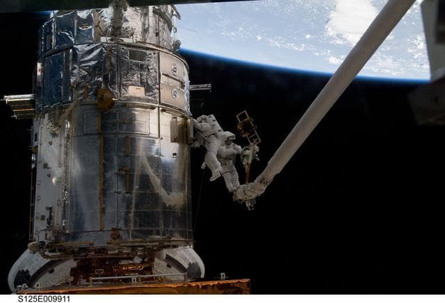 NASA image: STS-125 MS3 Grunsfeld and MS5 Feustel during EVA5