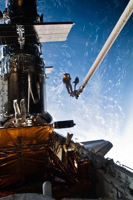 NASA image: STS-125 MS3 Grunsfeld and MS5 Feustel during EVA5