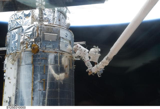 NASA image: STS-125 MS3 Grunsfeld and MS5 Feustel during EVA5