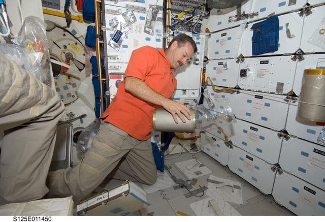NASA image: STS-125 CDR Scott Altman replaces LiOH Cannisters on the Shuttle Atlantis Middeck