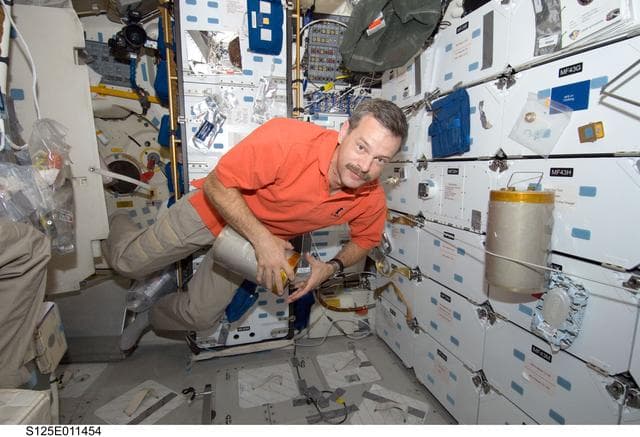 NASA image: STS-125 CDR Scott Altman replaces LiOH Cannisters on the Shuttle Atlantis Middeck